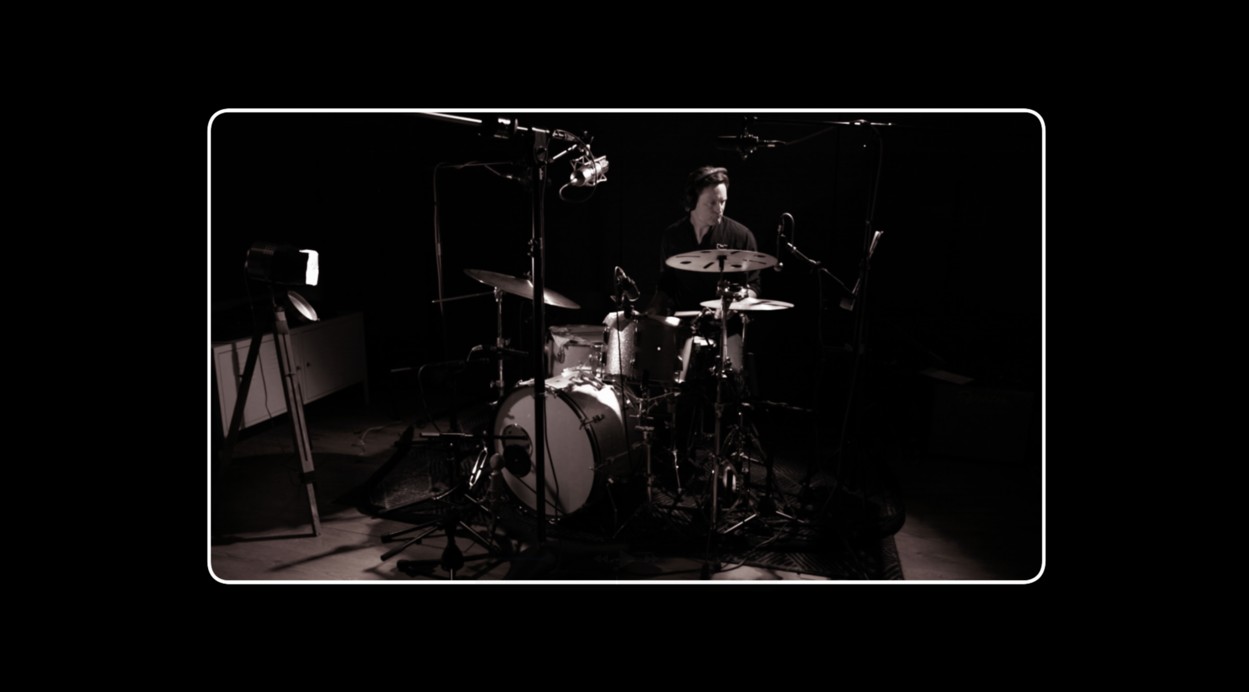 remote session drummer shot from the side of stage